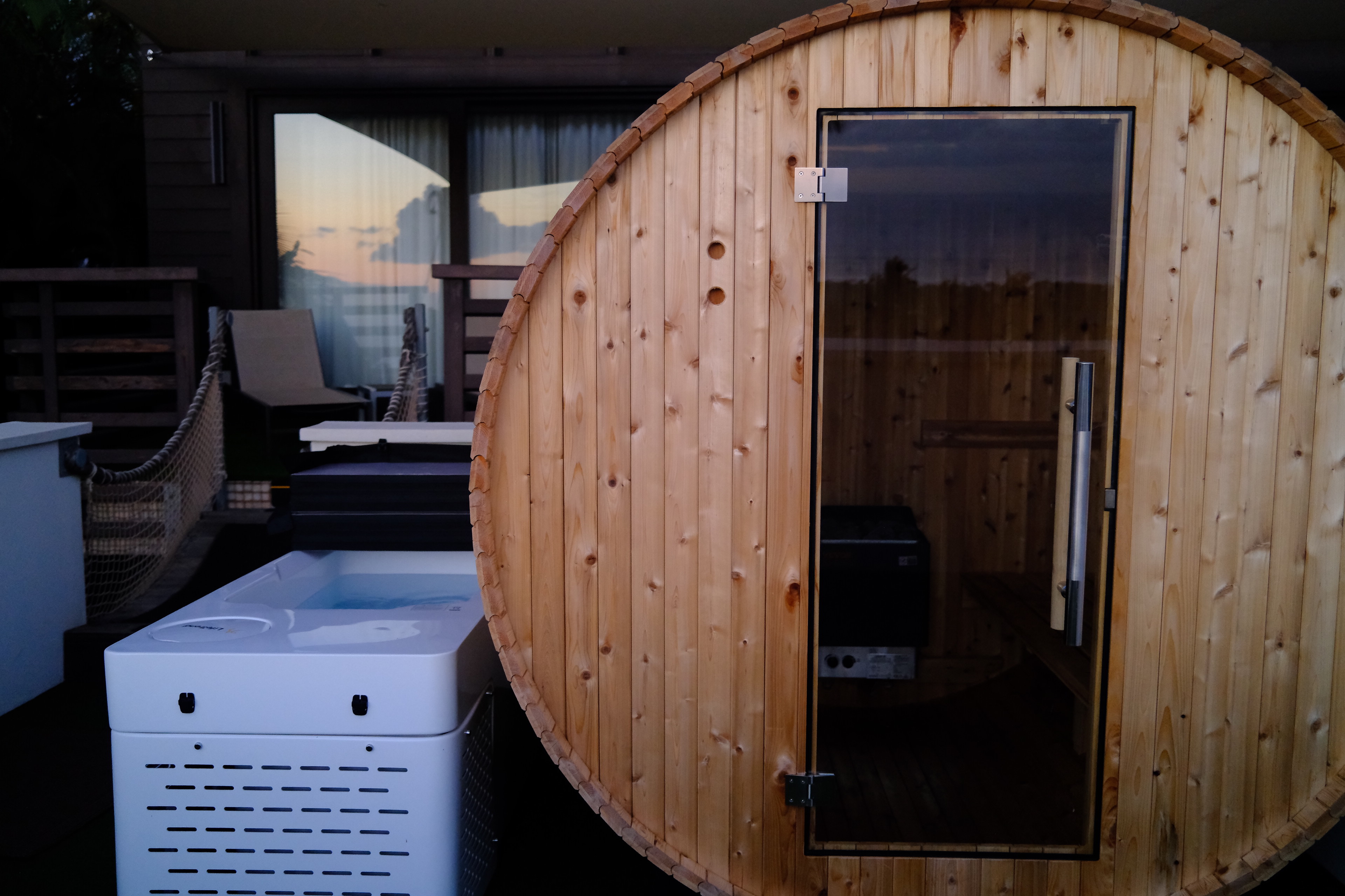 Cedar barrel sauna and cold plunge on the lanai at The Butterfly Home Maui at sunset